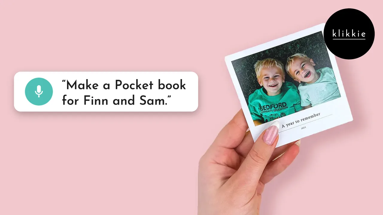 Photo book for kids: a hand holding a small klikkie Pocket photo book with two laughing boys on the cover, with a speech bubble saying make a Pocket book for Finn and Sam